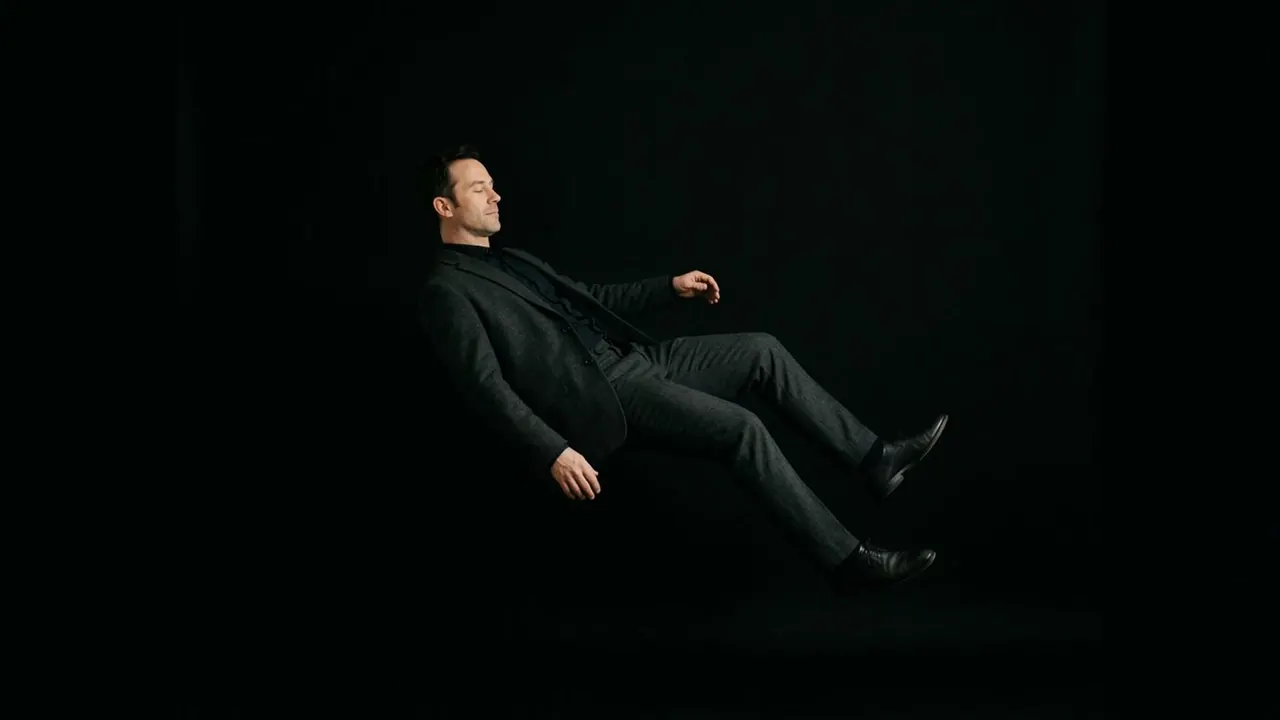 Floating Fall: A body drifts and turns in dark space with no ground.