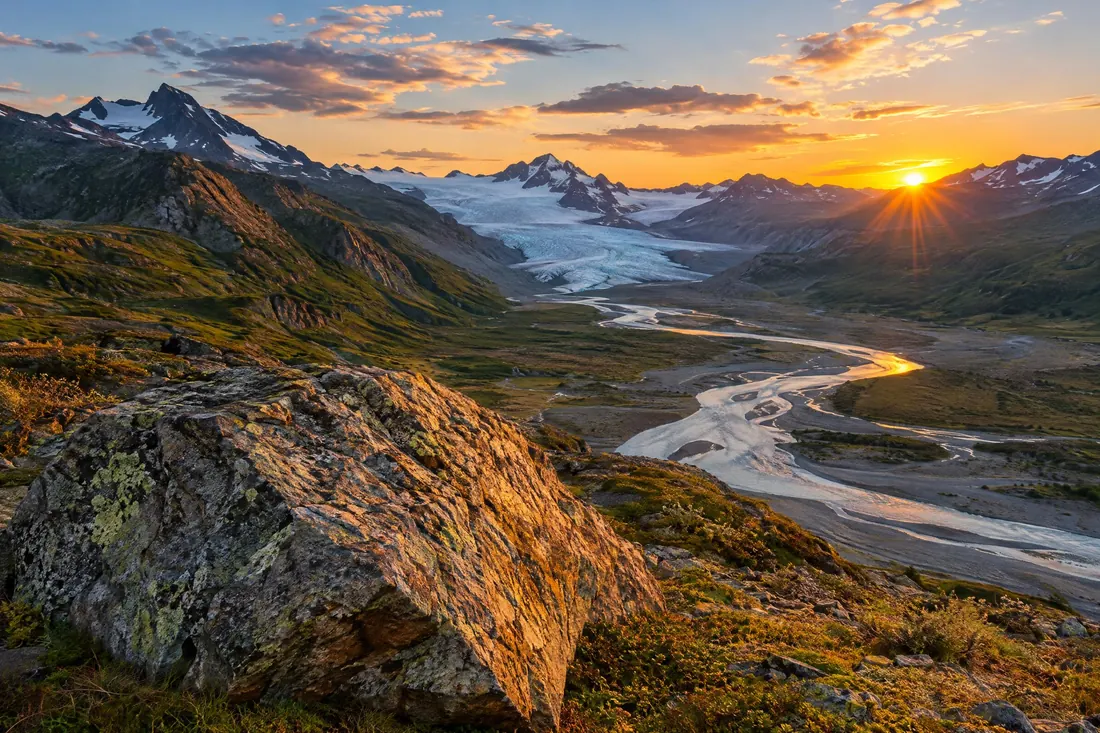 Landscape photography: A wide lens on a tripod at low sun, sharp from a near rock to a far ridge.